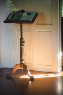 A pastor speaking warmly to a small group in a cozy, sunlit room filled with books and natural wood accents.