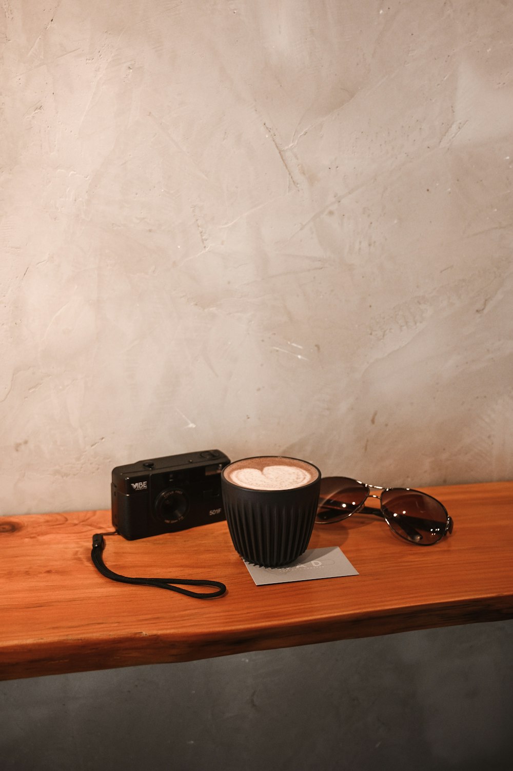 black sunglasses on brown wooden table