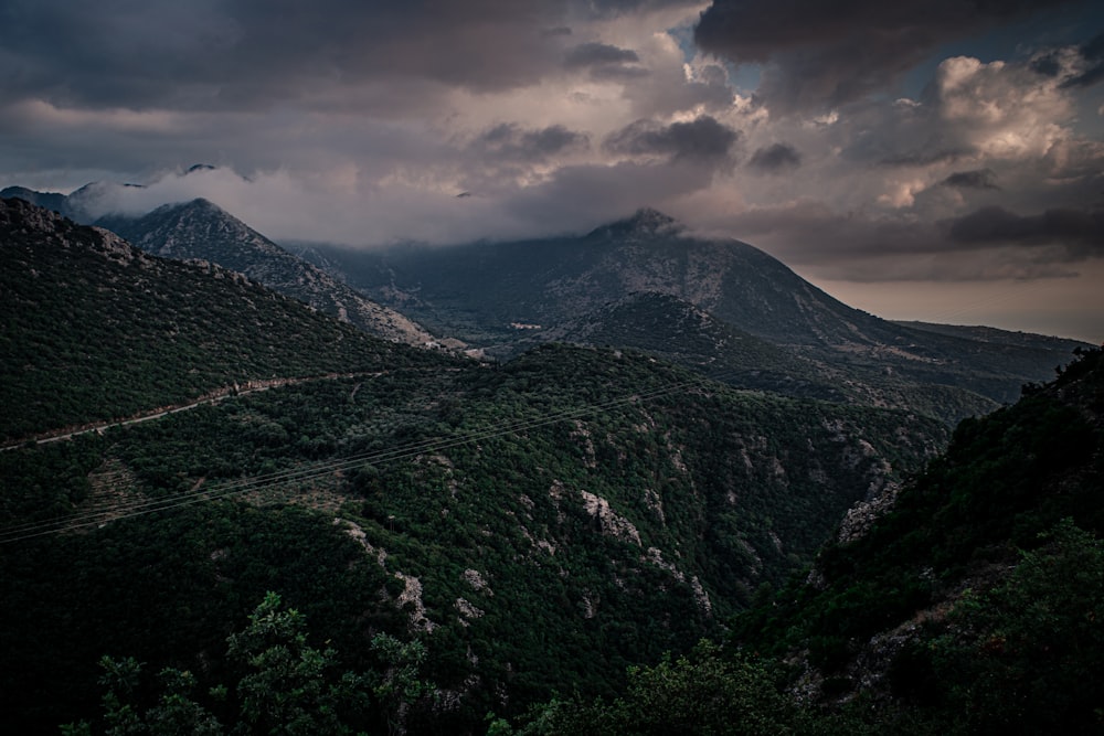 green mountain under cloudy sky during daytime