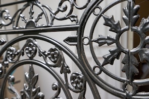 Rustic iron gates with intricate patterns ready for installation.