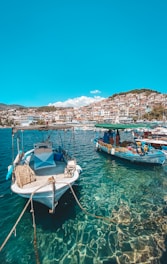 white and blue boat on sea during daytime