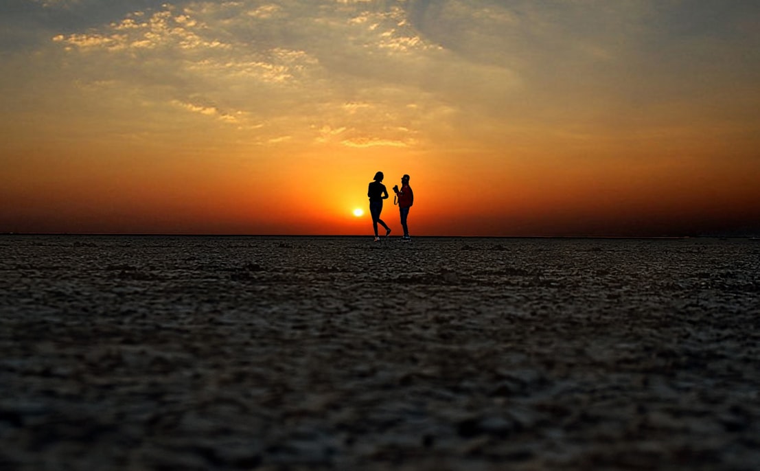 people on the beach during sunset