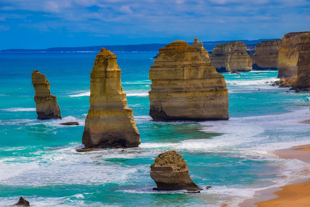 brown rock formation on blue sea under blue sky during daytime