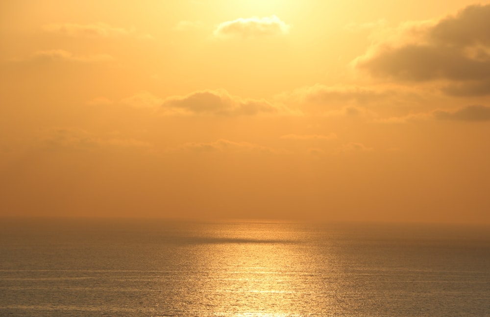 body of water during sunset