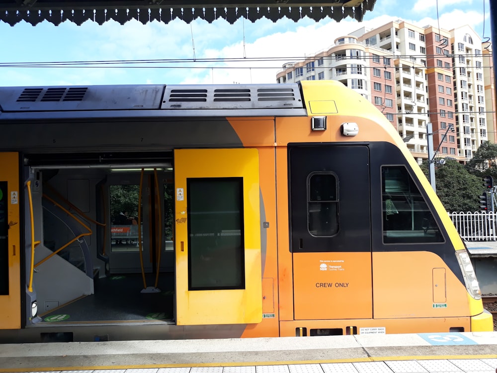 yellow and black train on rail during daytime
