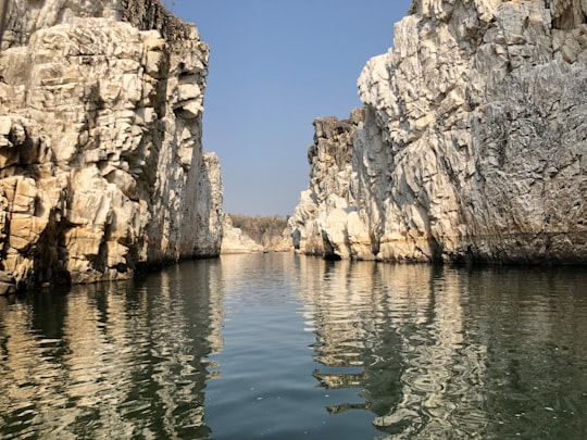 brown rocky mountain beside body of water during daytime in Bhedaghat India