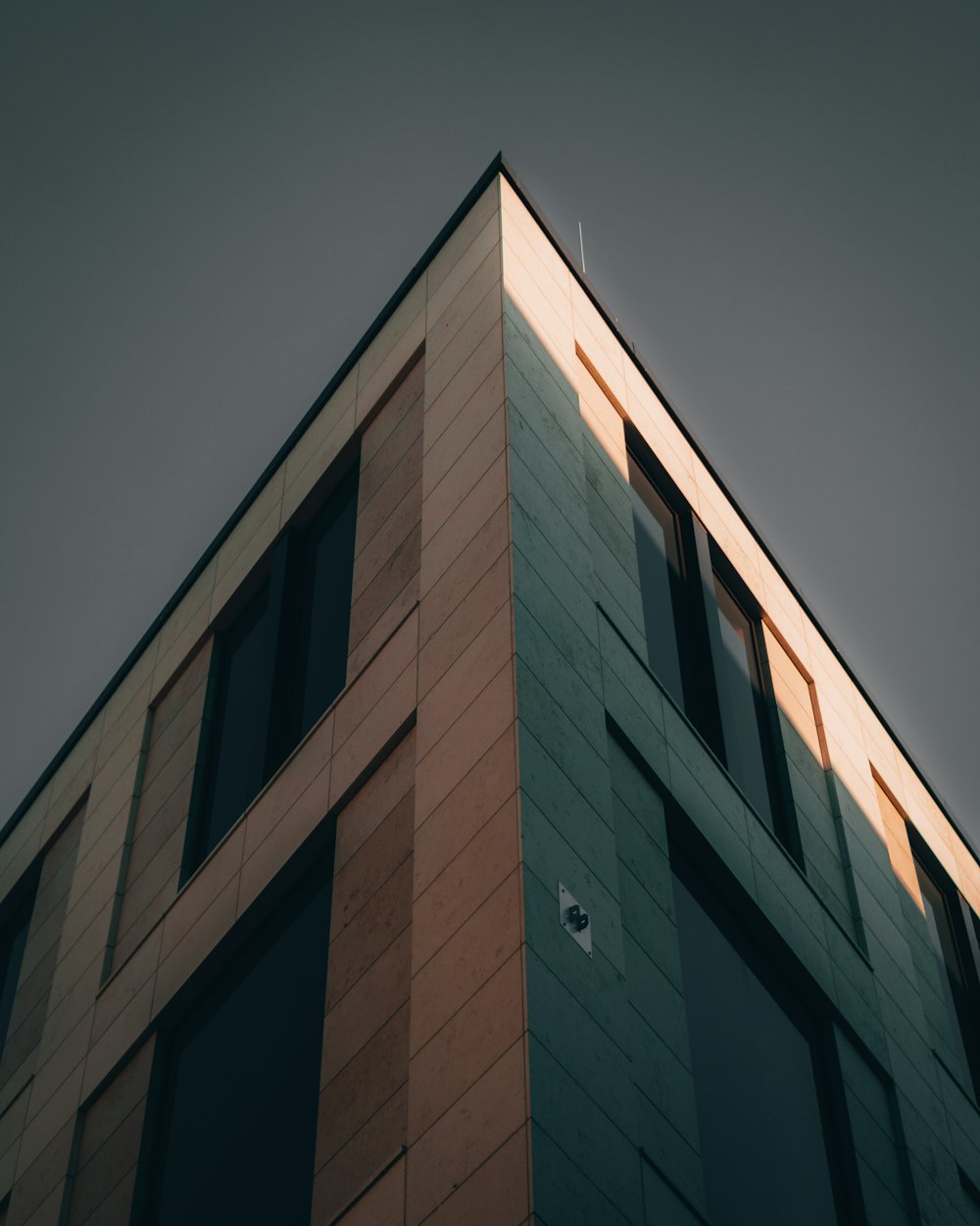 brown concrete building under gray sky