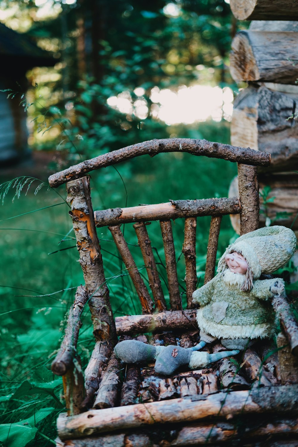 baby in gray and white dress sitting on brown wooden swing bench