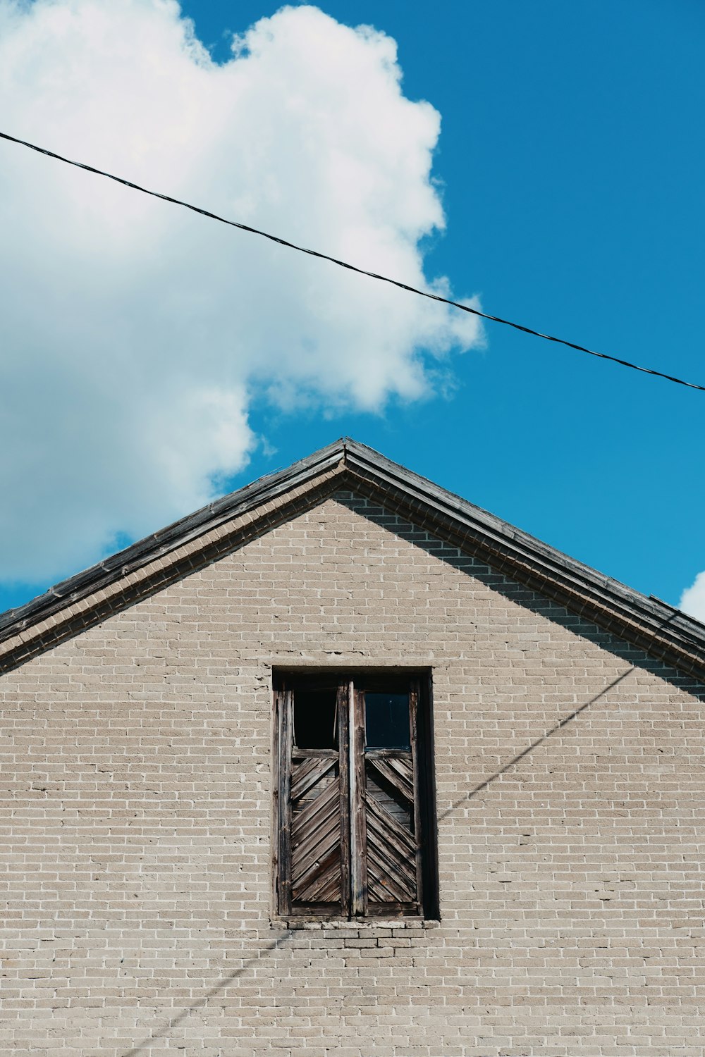 gray brick house under blue sky during daytime