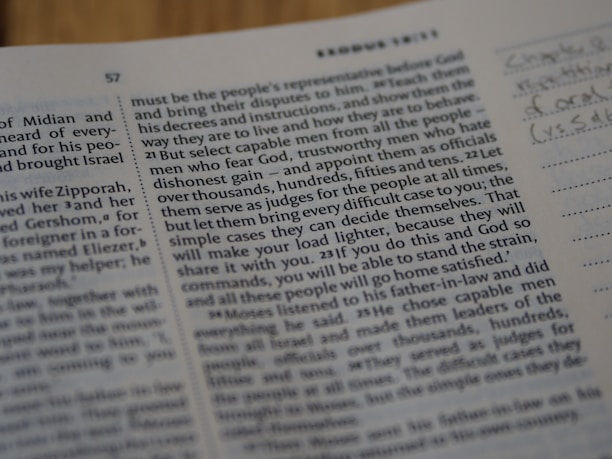 A close-up view of a book page showing printed text and a small section with handwritten notes on the side. The text includes numbers and is formatted in paragraphs.