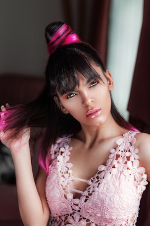 A stylish woman showing off a sleek new haircut with natural highlights.