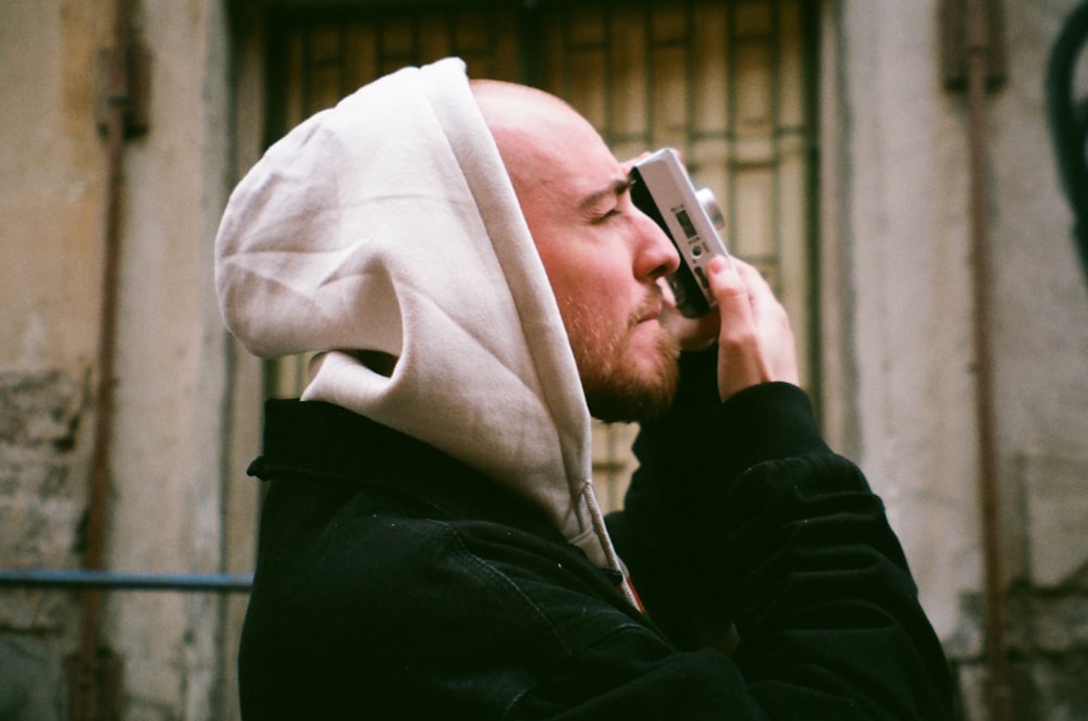 man in black jacket holding smartphone