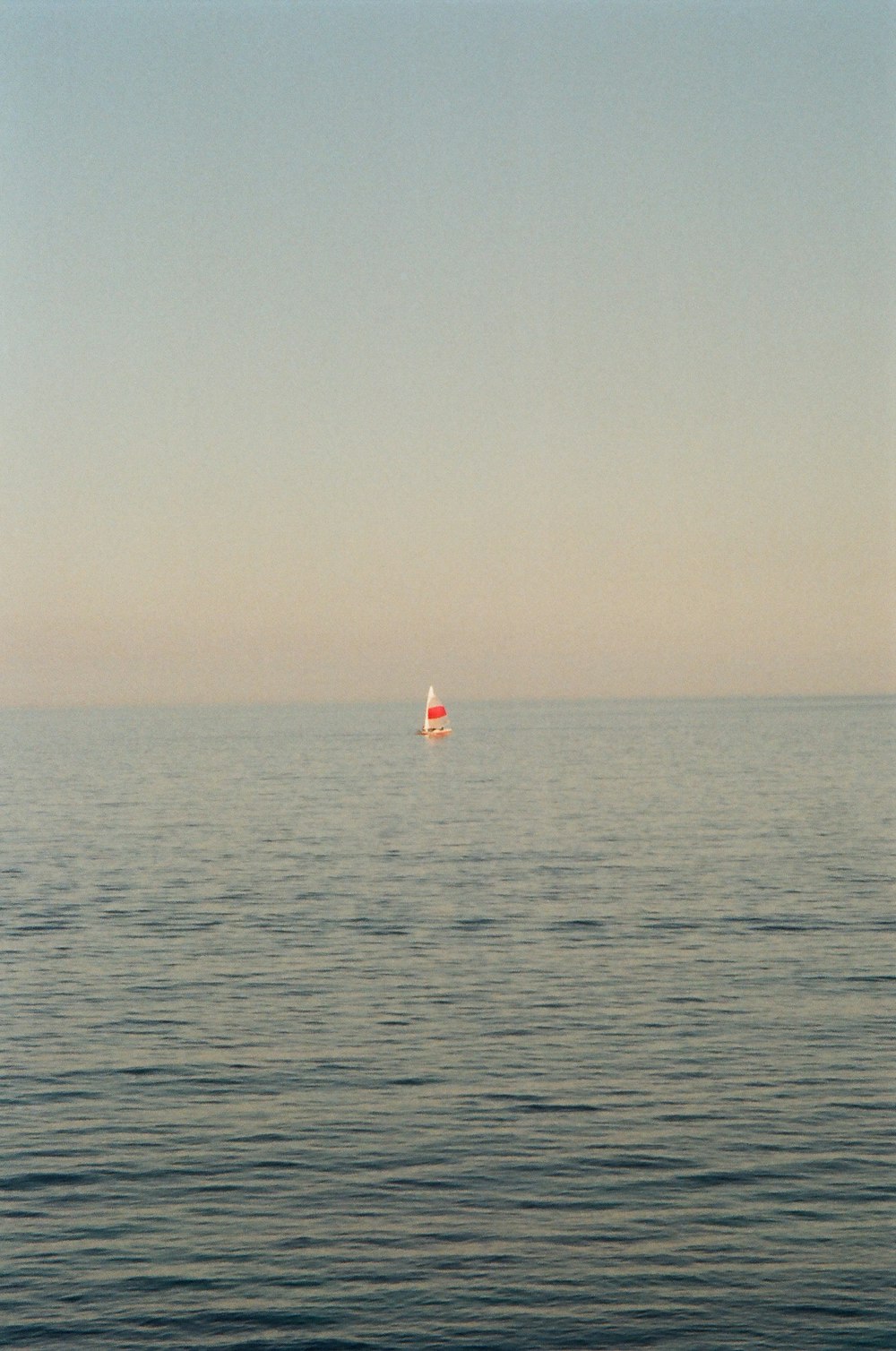 person in red shirt on body of water during daytime