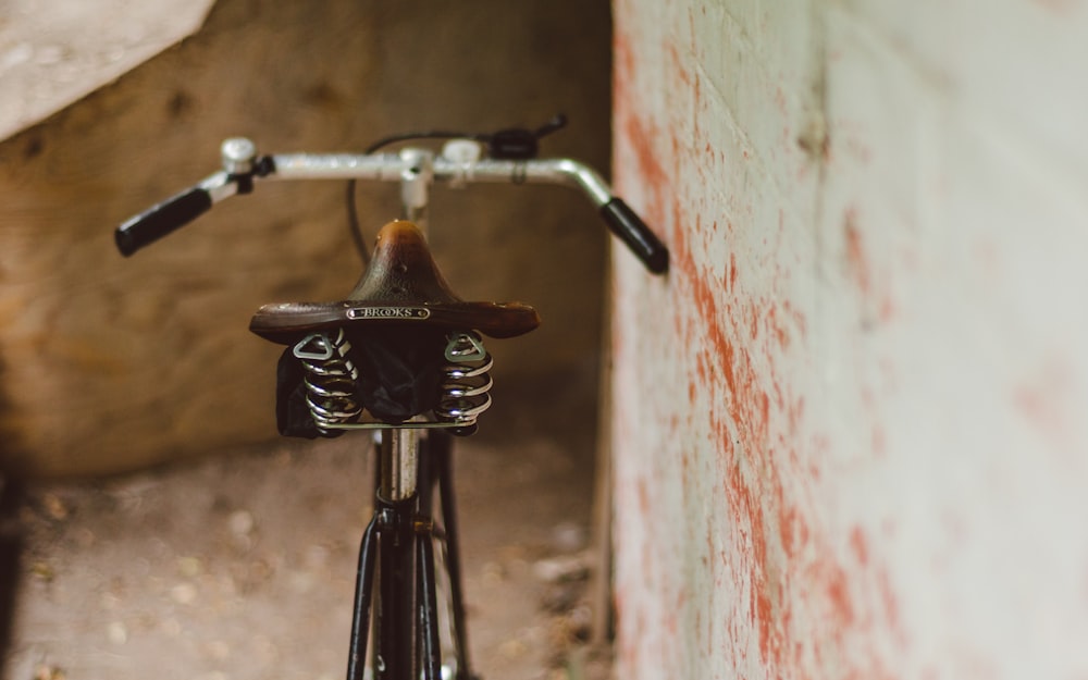 black bicycle handle bar with brown metal handle