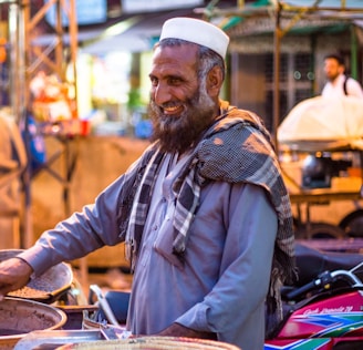 A friendly scrap dealer shaking hands with a customer in a busy Delhi market.