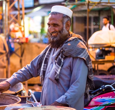 A friendly scrap dealer shaking hands with a customer in a busy Delhi market.
