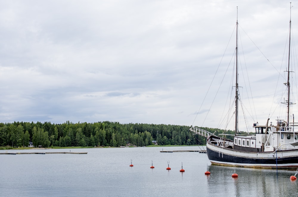 people riding on boat on lake during daytime