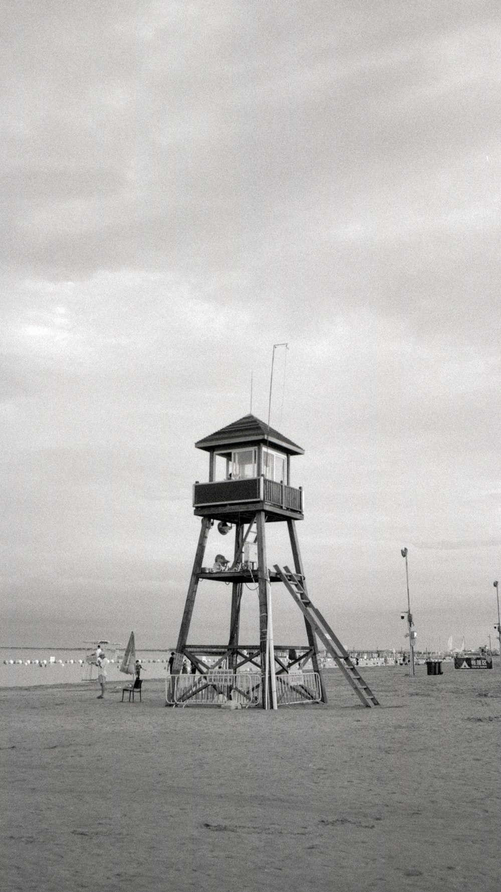 grayscale photo of people on beach