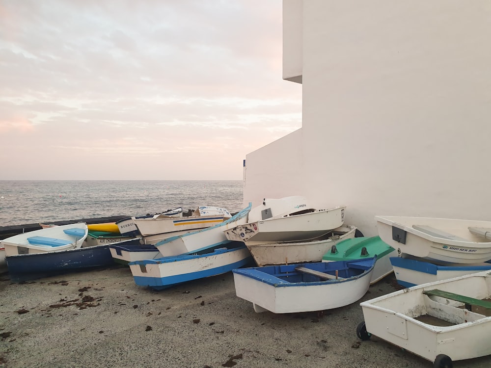 white and blue boats on beach during daytime