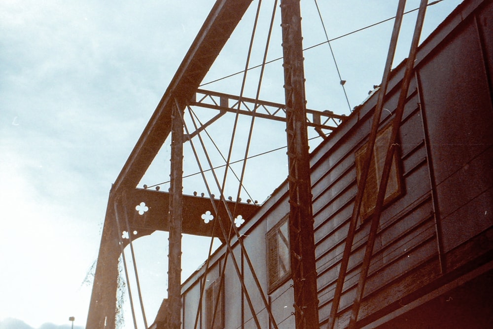 brown and white metal bridge under white clouds during daytime