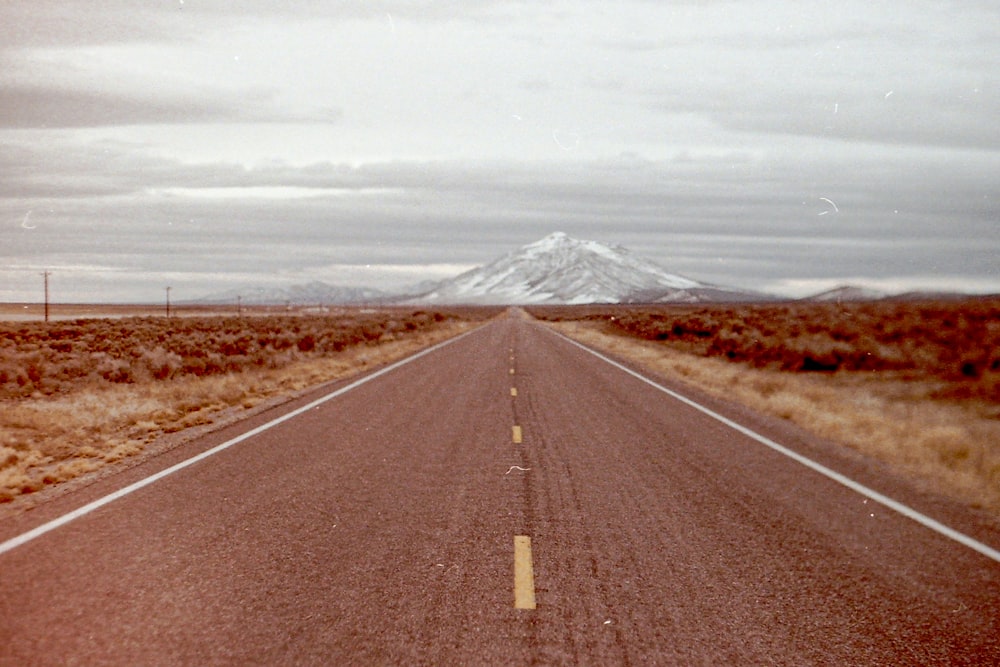 gray asphalt road under white sky during daytime