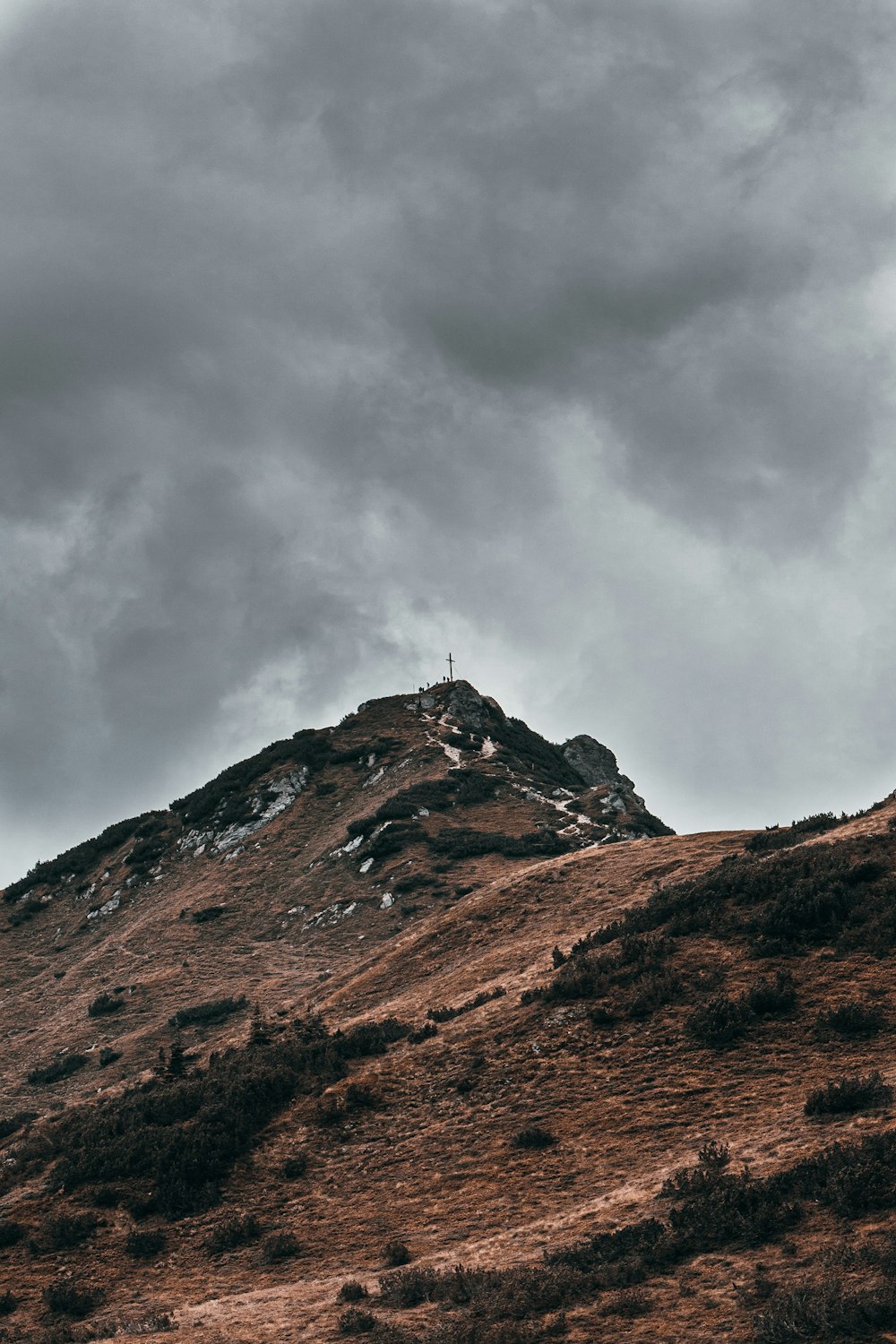 brown and green mountain under white clouds