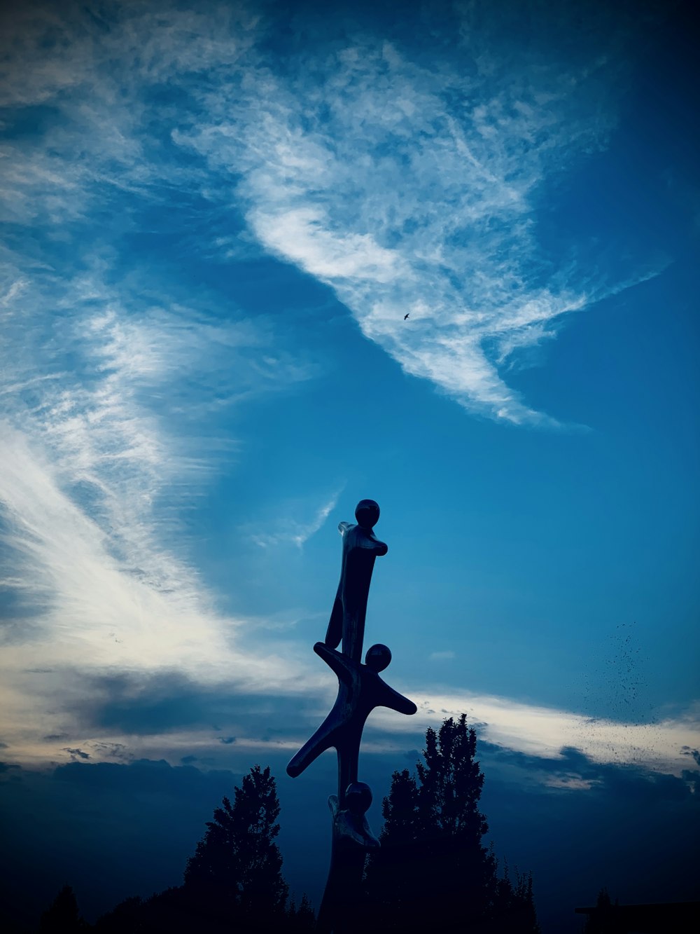 silhouette of man standing under blue sky during daytime