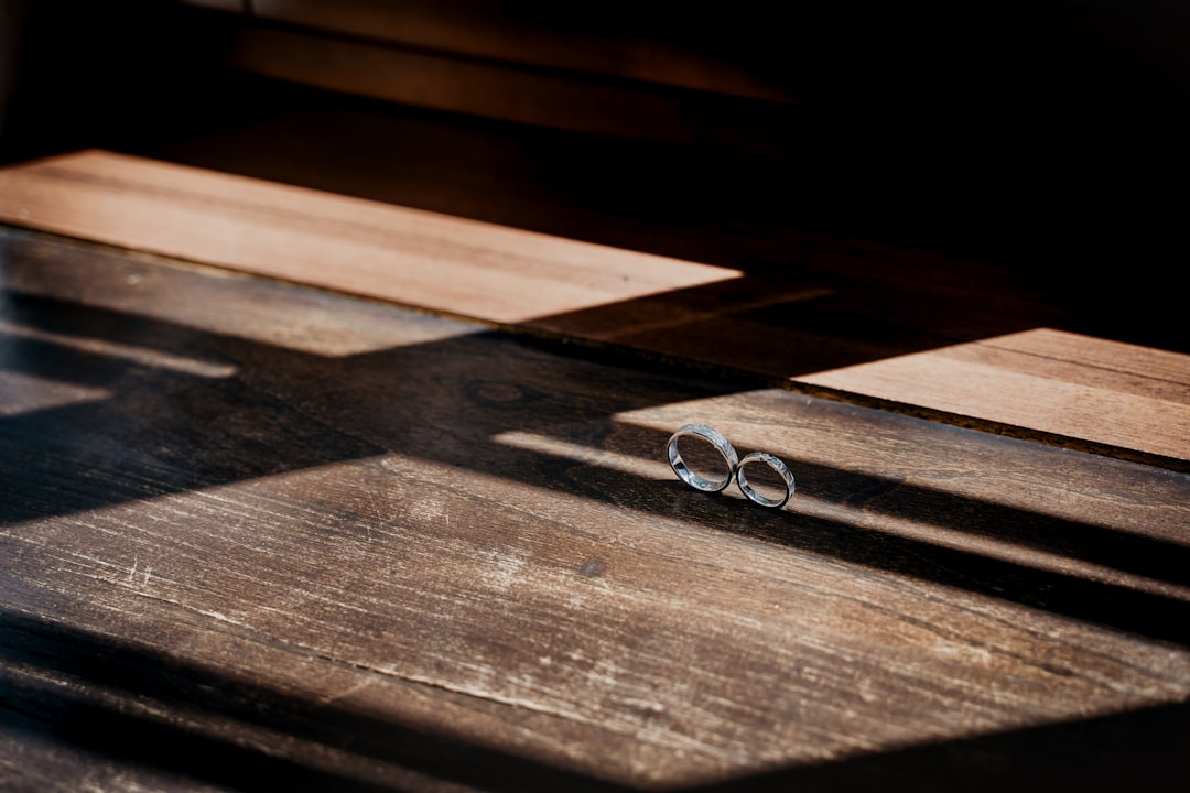 silver ring on brown wooden table