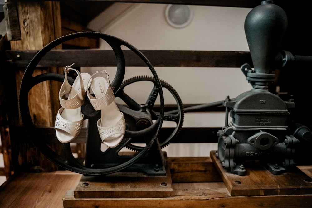 black leather sandals on brown wooden shelf