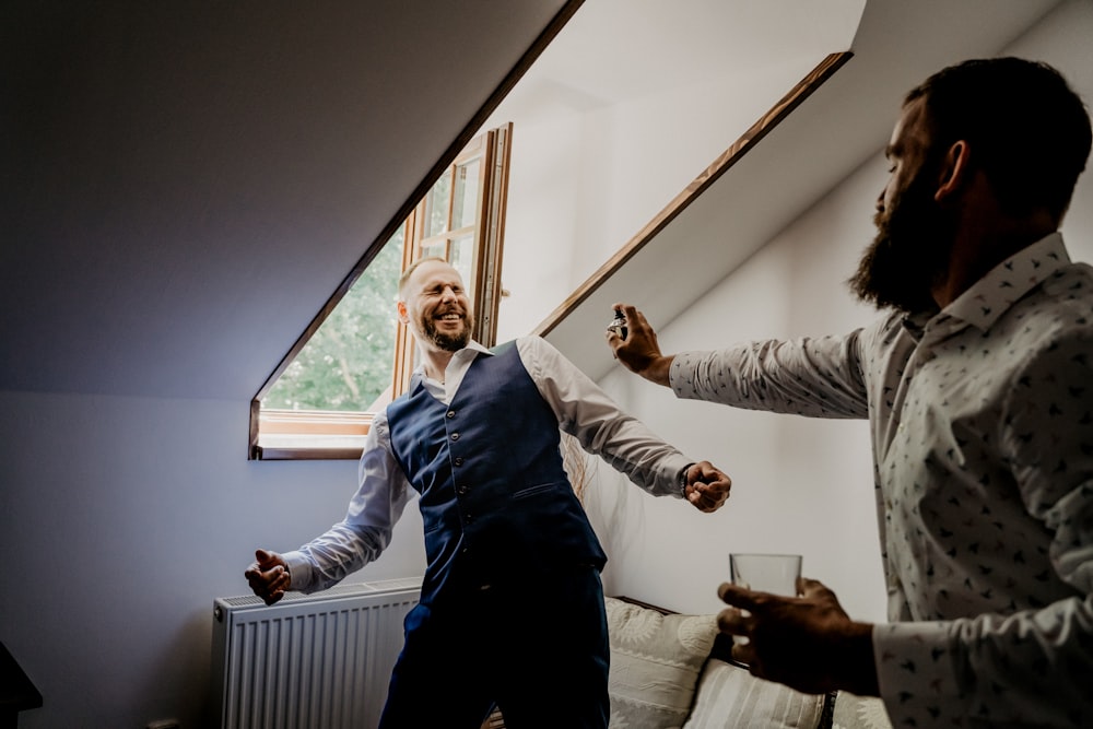 woman in gray long sleeve shirt and black pants standing beside window