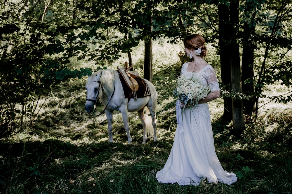 woman in white dress riding on white horse