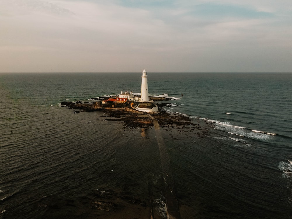 white lighthouse on island during daytime