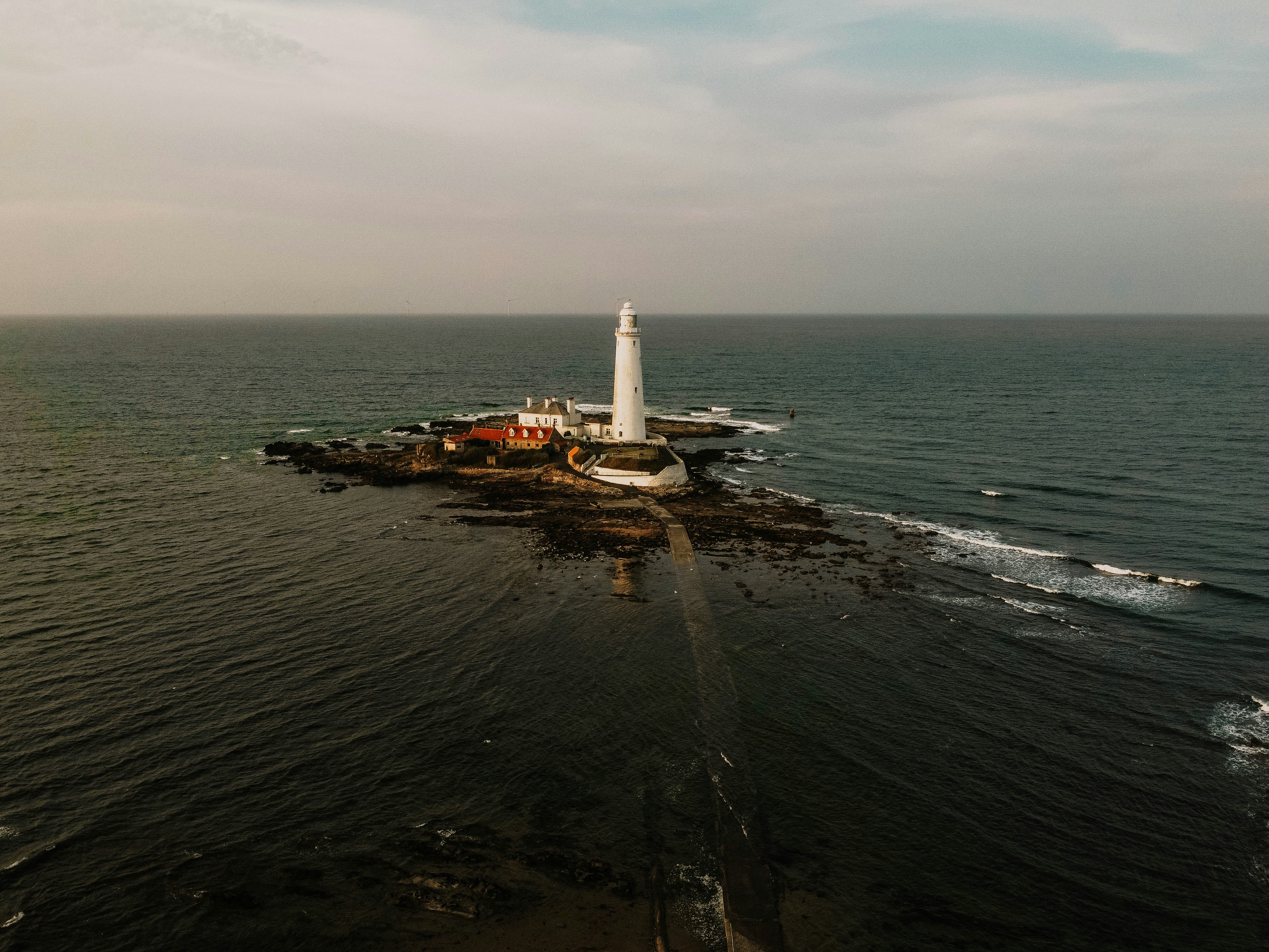white lighthouse on island during daytime
