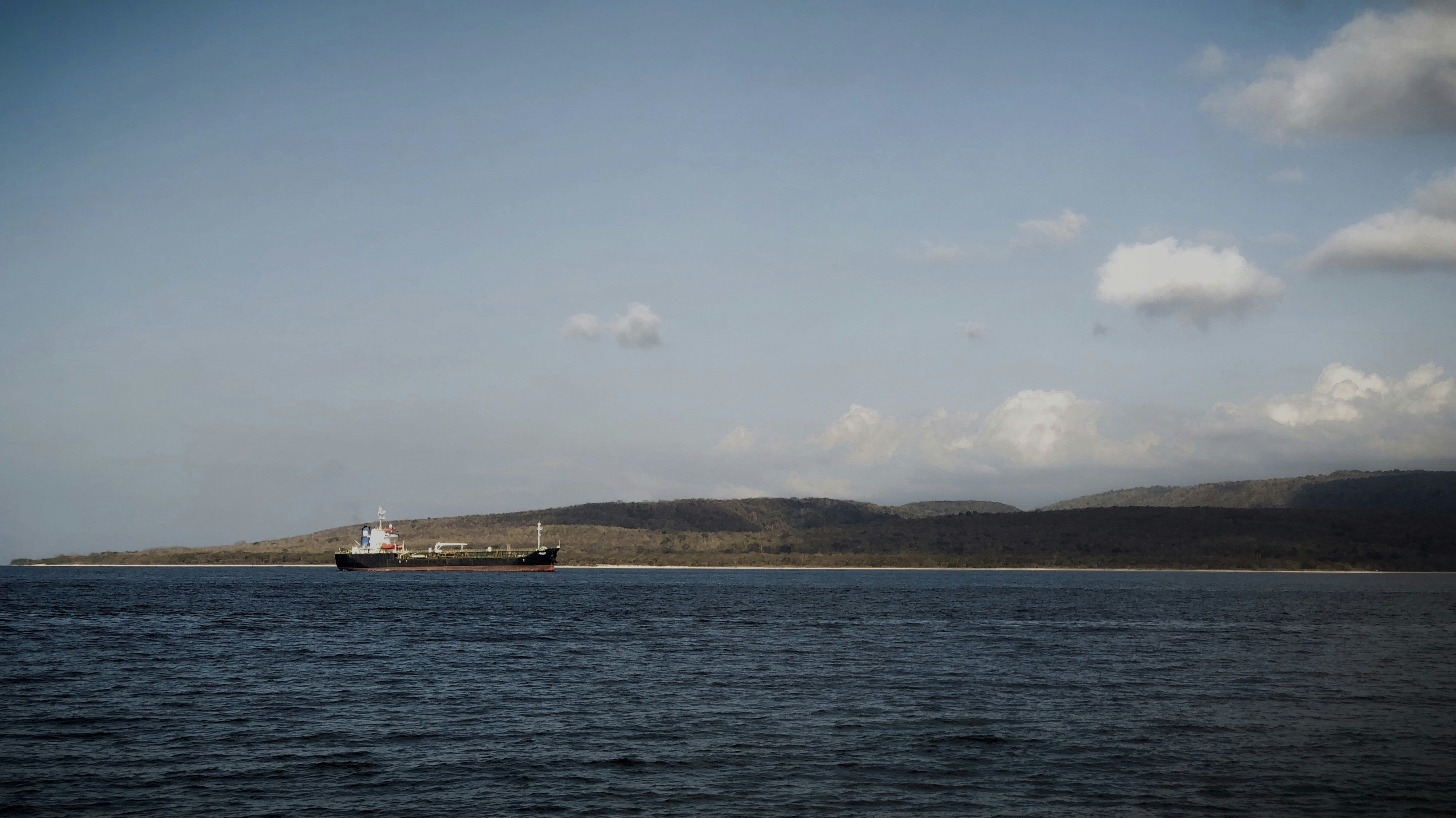 white ship on sea under blue sky during daytime