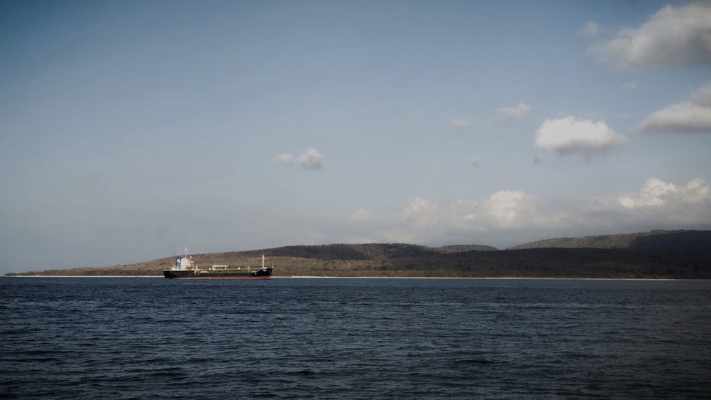 white ship on sea under blue sky during daytime