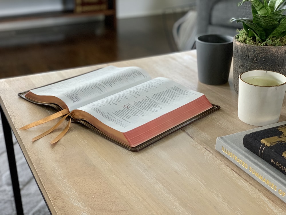 opened book on brown wooden table