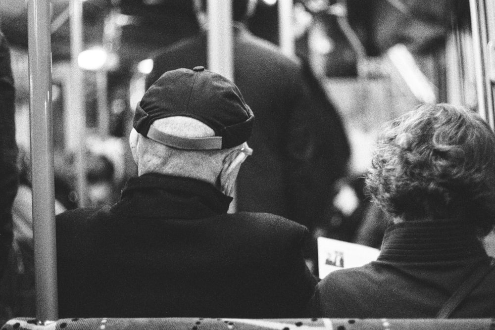 grayscale photo of man in black shirt and cap