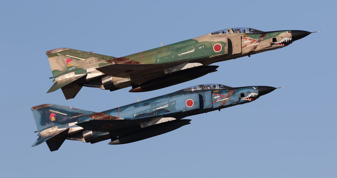 green and black fighter jet,
