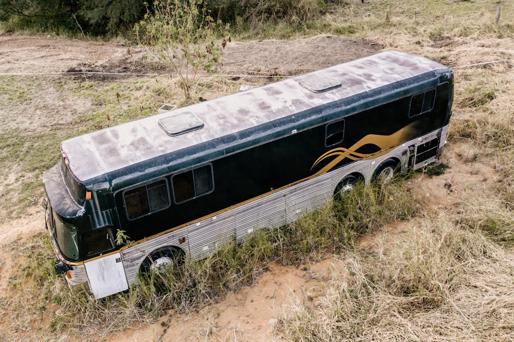 black and white bus on brown dirt road during daytime