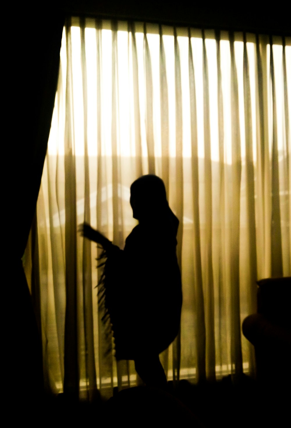 silhouette of person standing near window