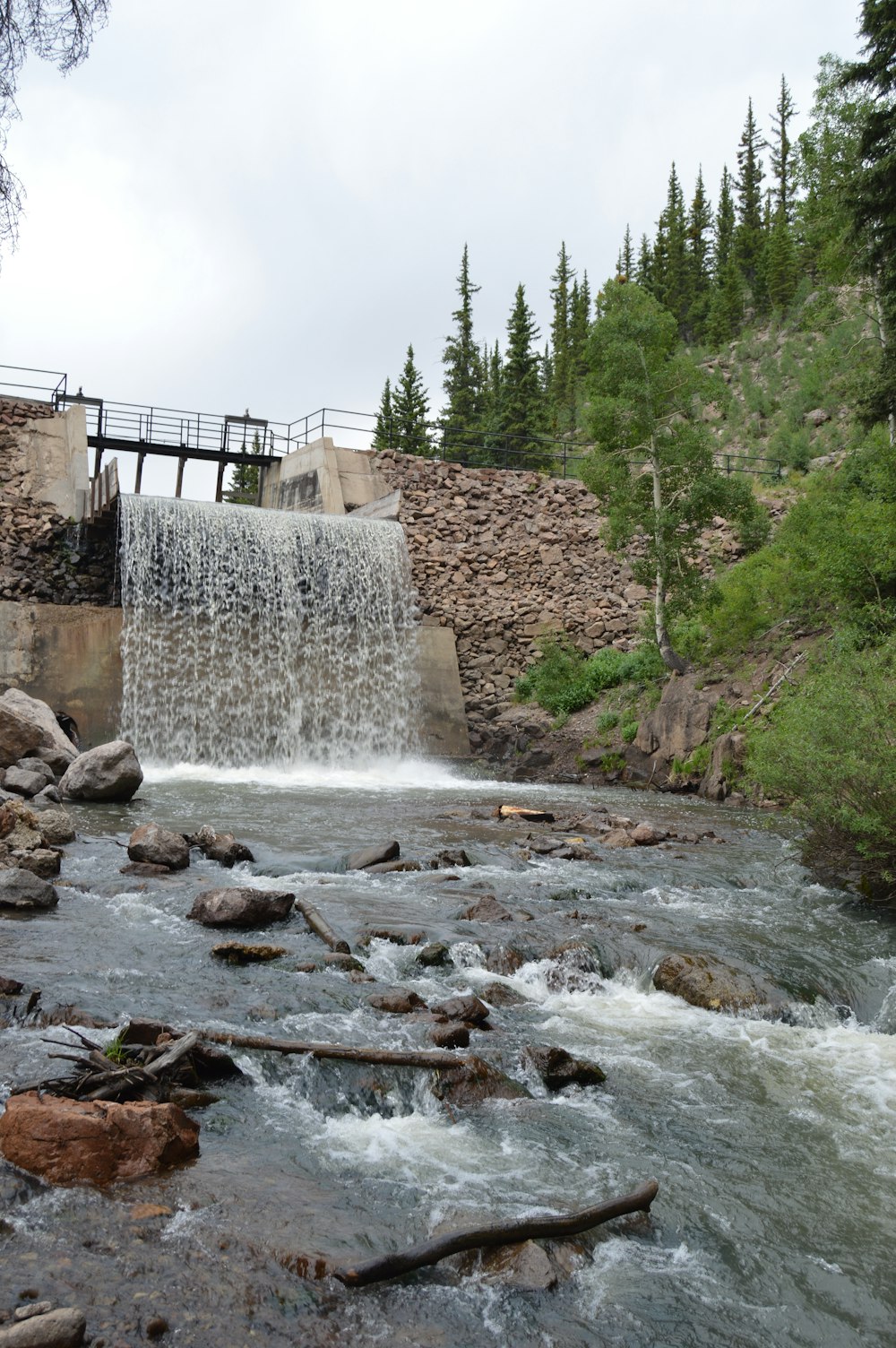 water falls near brown concrete building during daytime