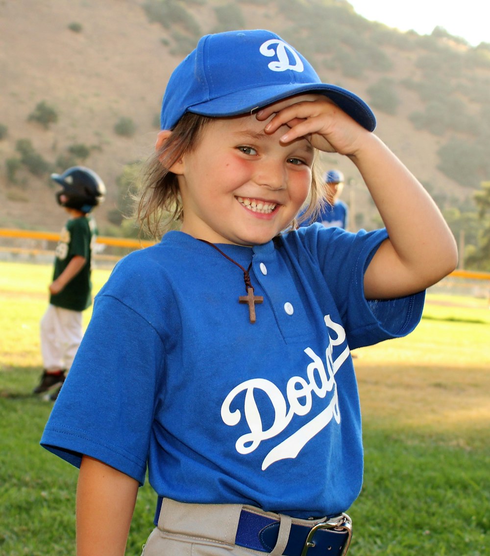 Fille en t-shirt à col rond violet et blanc portant une casquette de  baseball bleue photo – Photo Base-ball Gratuite sur Unsplash
