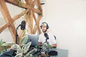 man in white crew neck t-shirt wearing black headphones