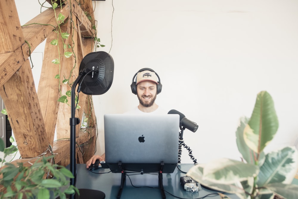 man in black headphones and macbook