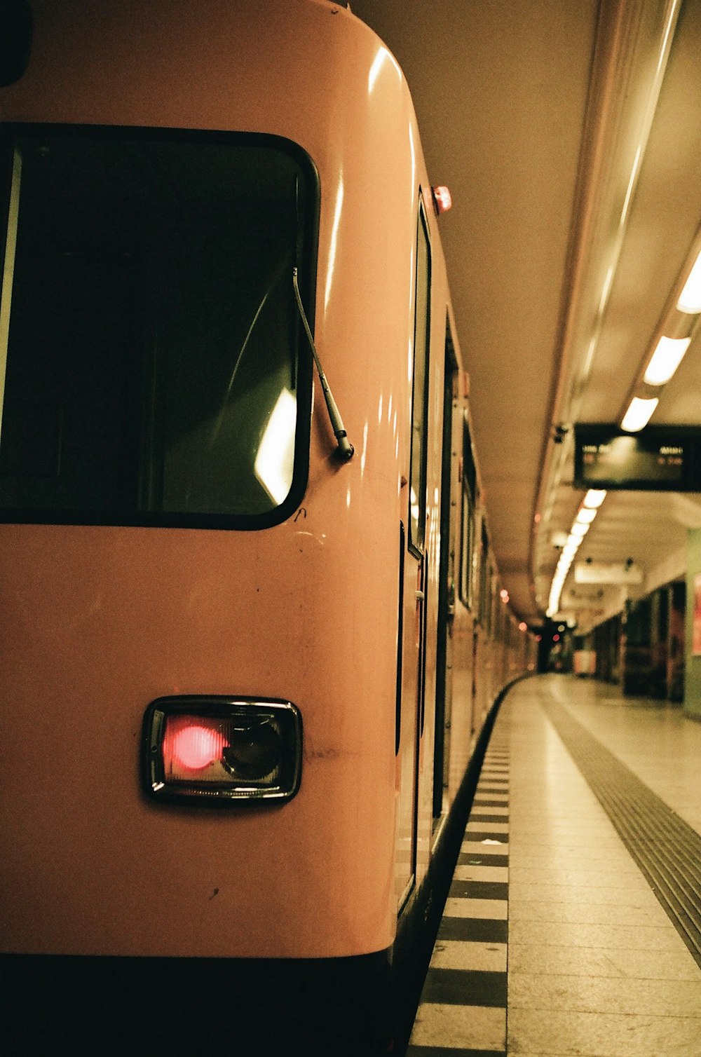 orange and black train in train station