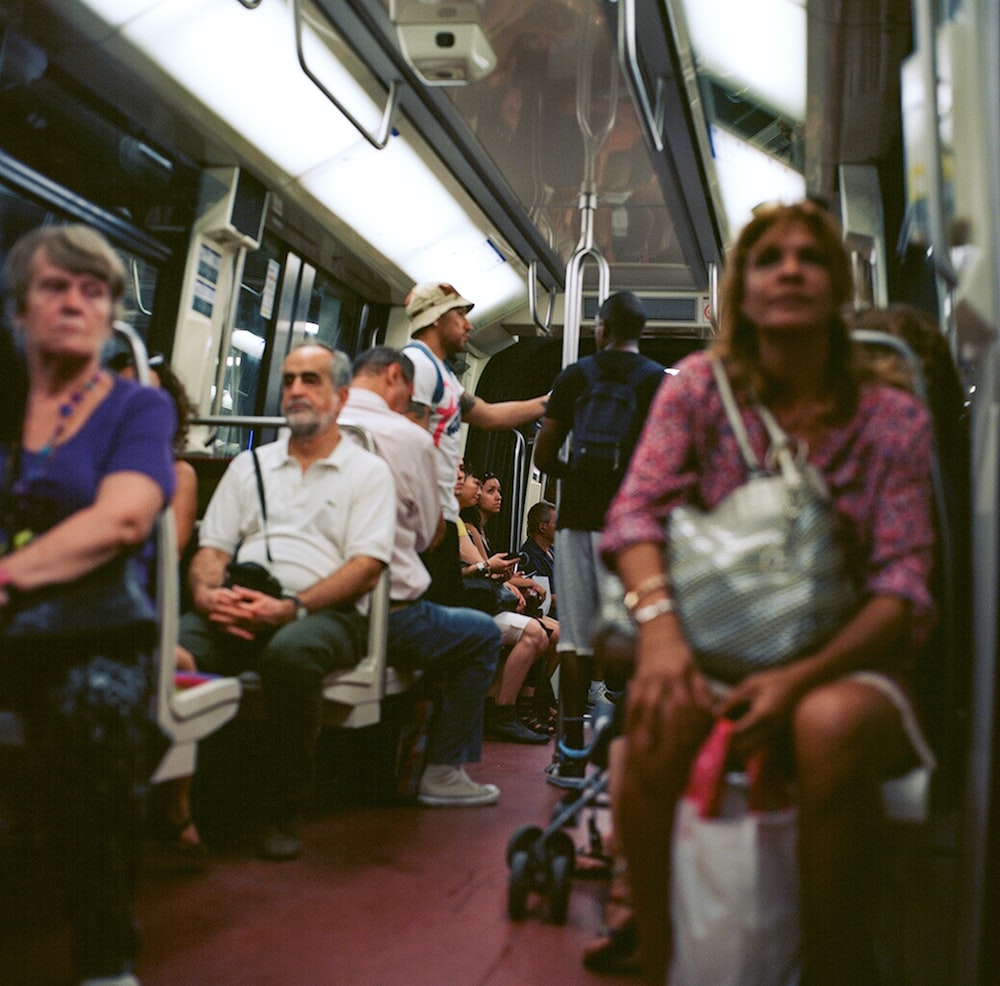 people sitting on train seat