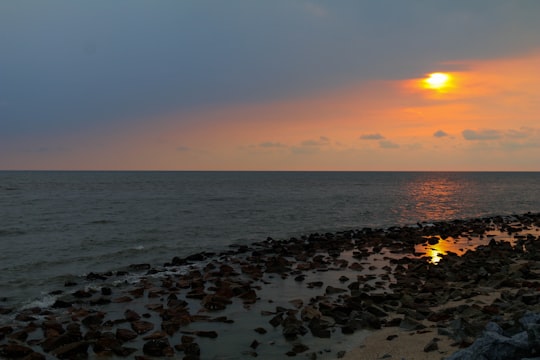 sea waves crashing on shore during sunset in Sekinchan Malaysia