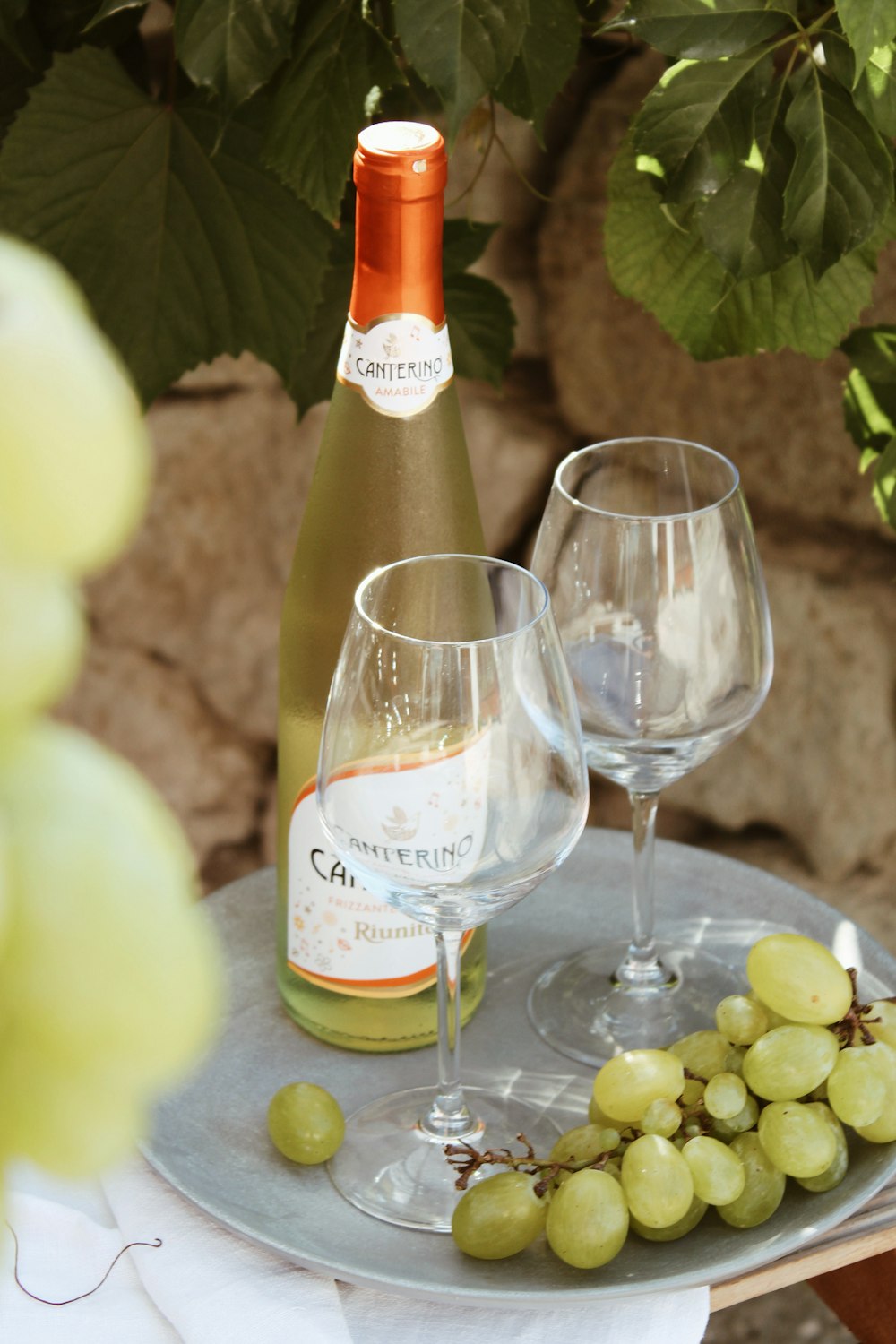 a bottle of wine and two wine glasses on a table