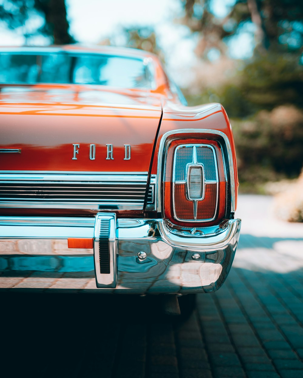 red chevrolet car in tilt shift lens