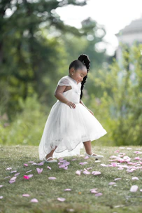 Child wearing simple, elegant clothing in a calm, natural setting.